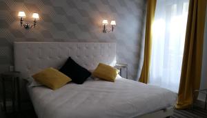 Postel nebo postele na pokoji v ubytování Régina Boutique Hotel