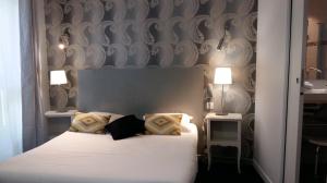 Postel nebo postele na pokoji v ubytování Régina Boutique Hotel