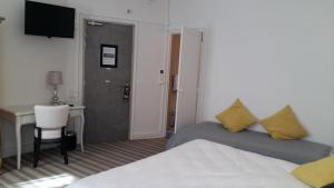 Postel nebo postele na pokoji v ubytování Régina Boutique Hotel