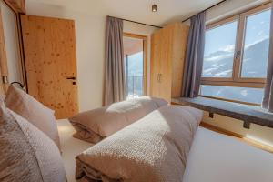 Postel nebo postele na pokoji v ubytování Lahnerhof Chalets