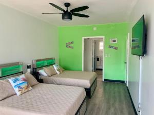 a bedroom with two beds and a ceiling fan at OCEANS 735 of DEERFIELD BEACH in Deerfield Beach +27 photos