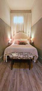 a bedroom with a large bed with a large window at Alma House - Caminha in Caminha