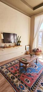a living room with a coffee table and a tv at Alma House - Caminha in Caminha