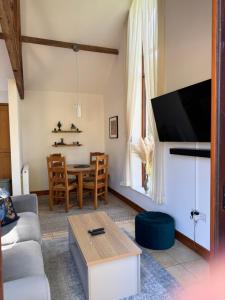 a living room with a couch and a table at Elm Barn in Diss