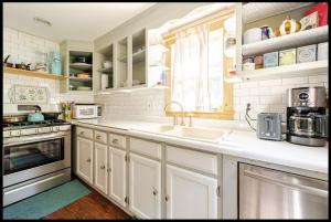 a kitchen with white cabinets and a sink at 2 bedroom Apt in Kingston