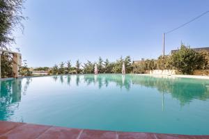 a large swimming pool with blue water at Masa La Bomba in Premiá de Mar