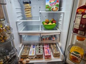 an open refrigerator with a bowl of fruit in it at The Culpepper Inn in Elizabeth City