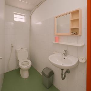 a bathroom with a toilet and a sink at Happy House Homestay in Hue