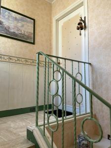 a green staircase in a room with a window at Appartement 3 pièces in Mareil-Marly +24 photos