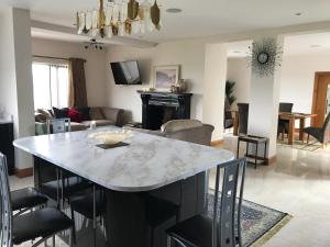 a kitchen and living room with a marble table and chairs at Serene luxurious Retreat with Sea Views, Entire Home Letterkenny in Letterkenny