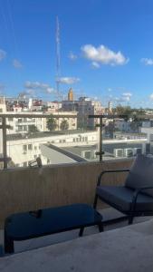 a balcony with a chair and a view of a city at Appartement centre ville kenitra in Kenitra