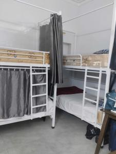 a group of bunk beds in a room at Cozy House in Hanoi