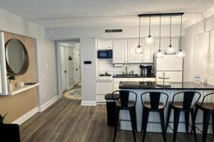 a kitchen and dining room with a table and chairs at Ocean View Condo in Daytona Beach