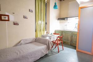 a living room with a couch and a table at lovingenoa Iter - Nos in Genoa +39 photos