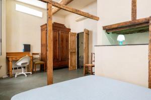 a bedroom with a bed and a desk at lovingenoa Iter - Nos in Genoa