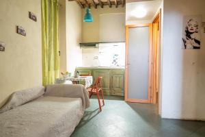 a living room with a couch and a kitchen at lovingenoa Iter - Nos in Genoa