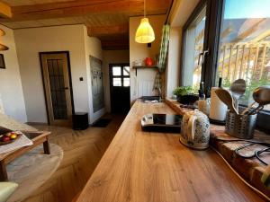 a kitchen with a wooden counter top in a room at Apartmán Stela in Spišské Tomášovce