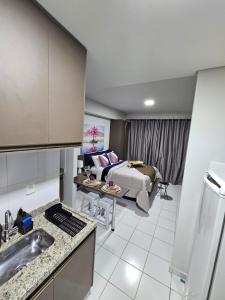 a kitchen and a living room with a bed at 1027 Apartamento Luxuoso! in Ribeirão Preto +23 photos