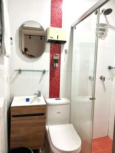 a small bathroom with a toilet and a sink at Apartamentos amoblados Puerto Nuevo in Ríohacha +15 photos