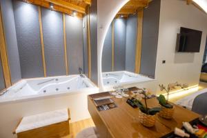 a large bathroom with a tub and a table at Villa Ester in Korçë +231 photos