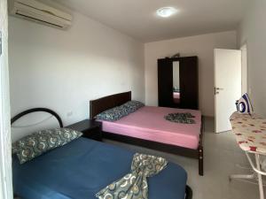 a room with two beds and a mirror at BlueWaveapartments 2 in Shëngjin