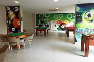 a room with tables and ping pong balls on the wall at Enjoy Olimpia Park Resort in Olímpia