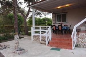 a patio with a table and chairs on a house at Vila 'Anna' in Krapets