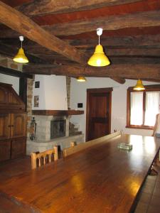 a dining room with a wooden table and a fireplace at Kerizara Baserria in Ochandiano