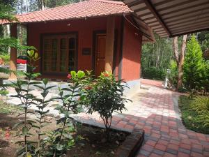 a small house with a plant in front of it at Todo estate stay coorg in Suntikoppa