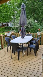 an umbrella sitting on top of a table on a deck at Mobil Home Kessler E036, Europapark, Rulantica in Boofzheim