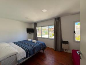 a bedroom with a bed and a window at Complejo Turistico Open Club in Paraná +76 photos