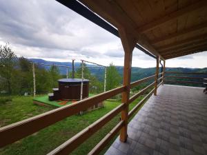 a view from the deck of a house with a hot tub at Casa din Dâmb Mătișești in Mătişeşti