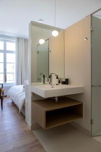 a bathroom with a sink and a large mirror at EVERELMUS Boutique Hotel in Bruges +88 photos