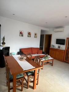 a living room with a table and a couch at Can Sais in Pals