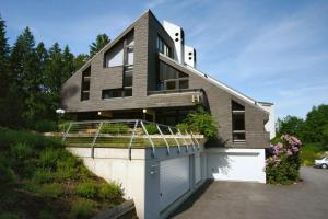 a black house with a white garage at Hotel Leitgebhof in Innsbruck