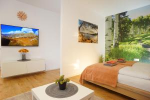 a bedroom with a bed and paintings on the wall at RELAX - ORANGE mit Pool und Sauna in Sonthofen +45 photos