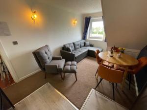 a living room with a couch and a table at The Ashleigh in Paignton