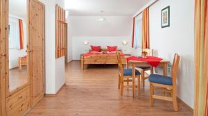a kitchen and dining room with a table and chairs at Gästehaus Lutschounig in Faak am See +71 photos