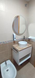 a bathroom with a white sink and a mirror at Magnifico apartamento de playa in Moncófar +22 photos