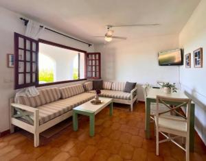 a living room with a couch and a table at Apartamento familiar en Son Bou in Son Bou
