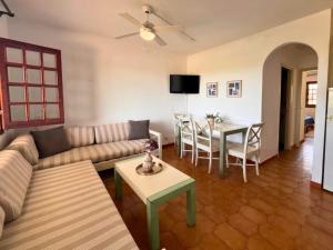 a living room with a couch and a table at Apartamento familiar en Son Bou in Son Bou
