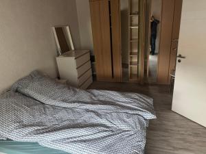 a bedroom with a bed and a person in a mirror at Ferienhaus Frida in Lauchhammer