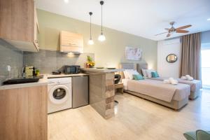 a kitchen and a living room with a bed and a bathroom at Diamond Apartments 4 in Kardamaina