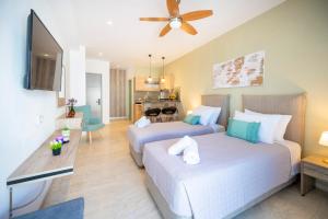 a bedroom with two beds and a living room at Diamond Apartments 4 in Kardamaina