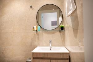 a bathroom with a sink and a mirror at Diamond Apartments 4 in Kardamaina
