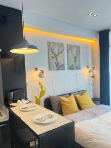 a room with a bed and a table with plates on it at Stay In GAUTHIER studio s in Casablanca