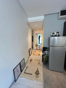 a living room with a refrigerator and two rugs at Stay In GAUTHIER studio s in Casablanca
