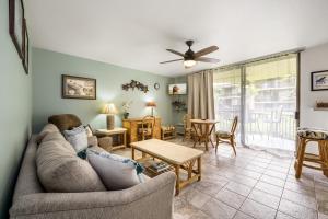 a living room with a couch and a table at Kona Makai Private Tropical Suites with Pool in Kailua-Kona +24 photos