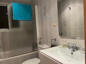 a bathroom with a sink and a toilet and a shower at Delta star apartaments in Sant Carles de la Ràpita +13 photos