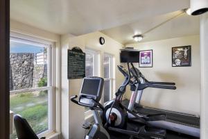 a room with a gym with a treadmill and a window at Kona Makai Private Tropical Suites with Pool in Kailua-Kona